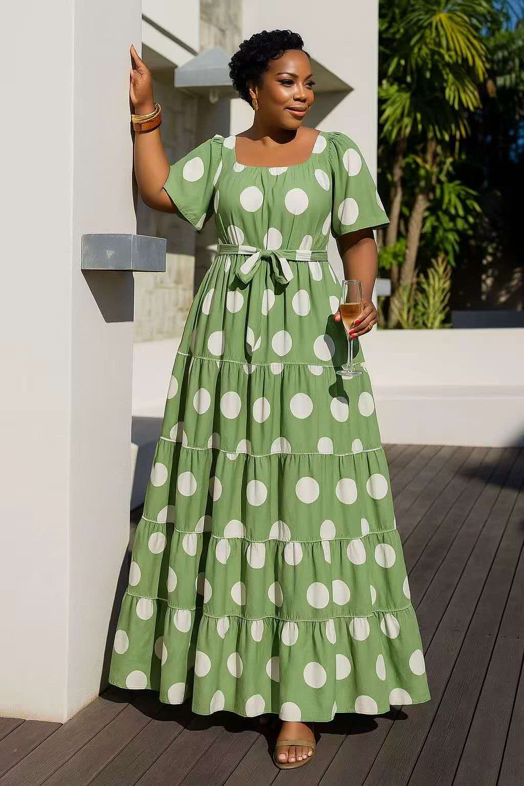 Tiered polka dot midi dress in mint green with white spots, short sleeves, belted waist