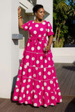 Tiered polka dot midi dress in hot pink with white spots, short sleeves, belted waist