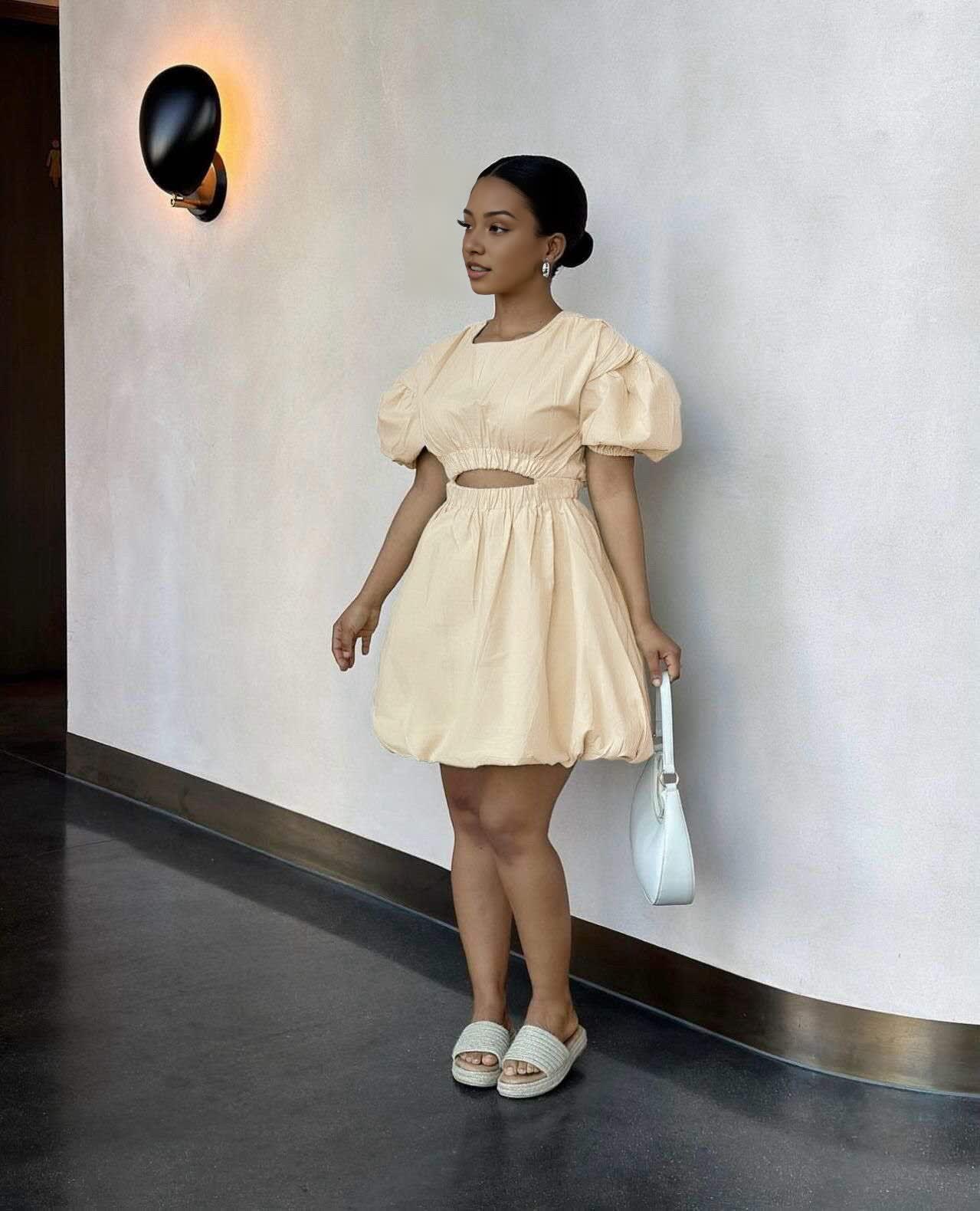 Tan mini dress with puff sleeves and cut-out waist