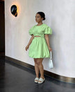 Mint-green mini dress with puff sleeves and cut-out waist