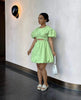 Mint-green mini dress with puff sleeves and cut-out waist