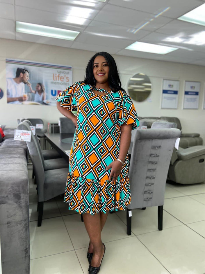 Plus-size geometric print dress with short sleeves and ruffle hem