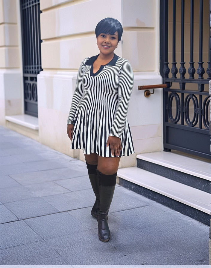 Black-and-white striped pleated knit mini dress with long sleeves and V-neck