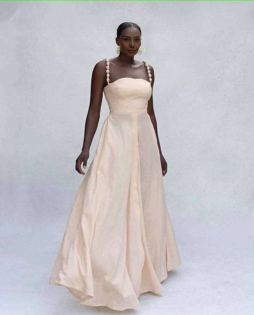 Cream maxi dress with square neckline, pom-pom straps, A-line flared skirt