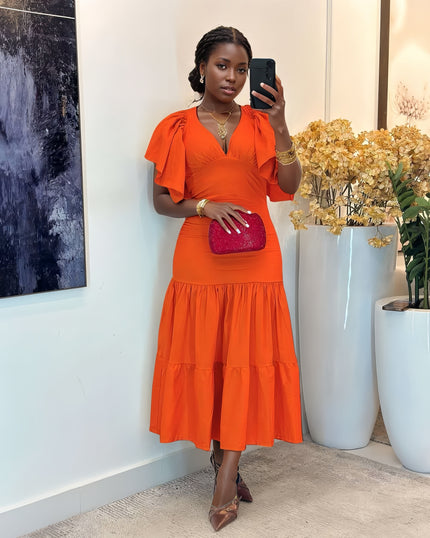 Orange-red tiered midi dress with flutter sleeves, V-neck, and fitted waist