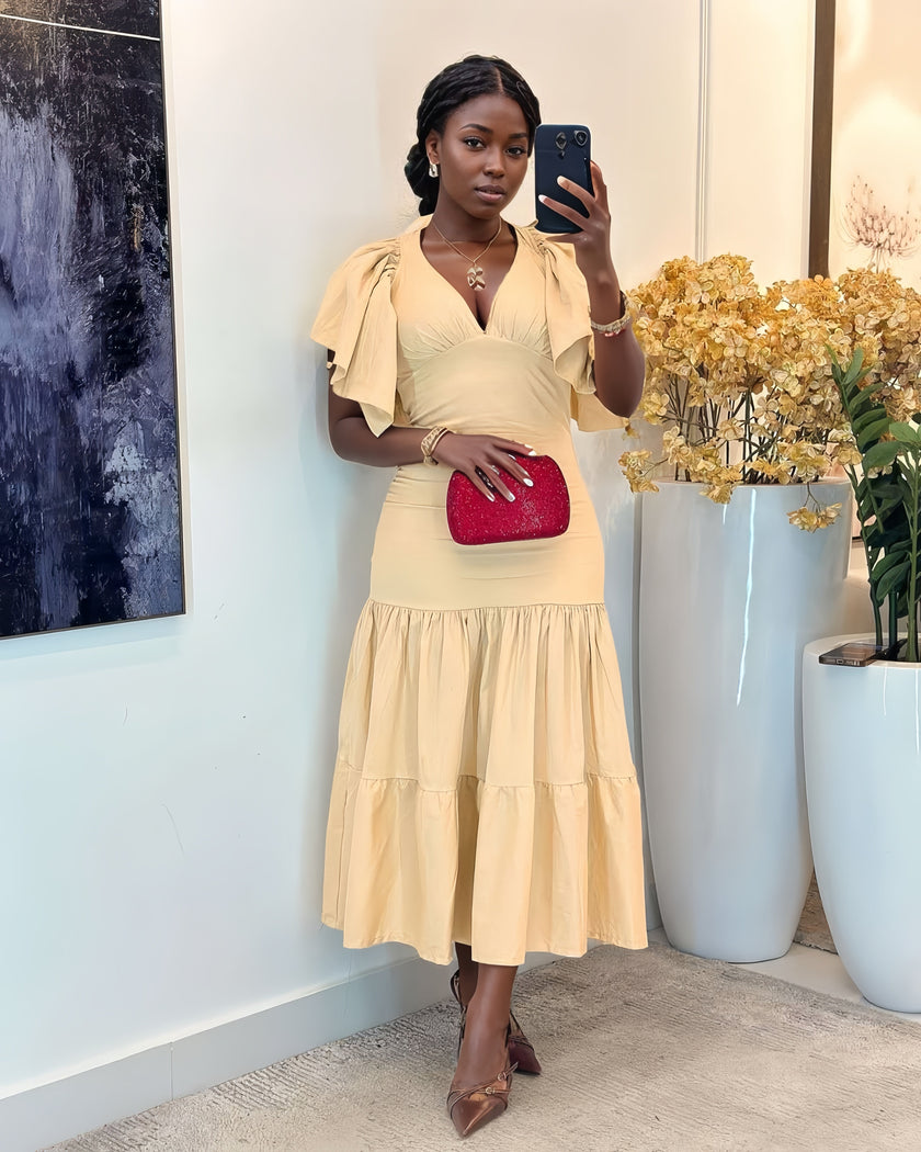 Beige tiered midi dress with flutter sleeves, V-neck, and fitted waist