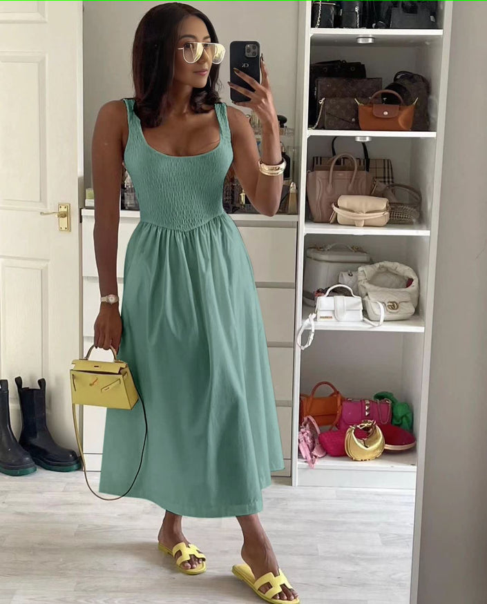 Turquoise sleeveless textured midi dress with square neckline and flared skirt.