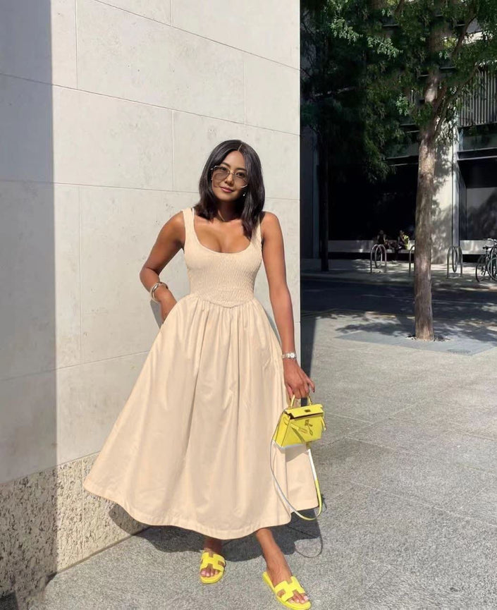 Light cream sleeveless midi dress with square neckline and flared skirt.
