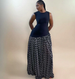 Sleeveless maxi dress with dark fitted bodice and black skirt with white floral print
