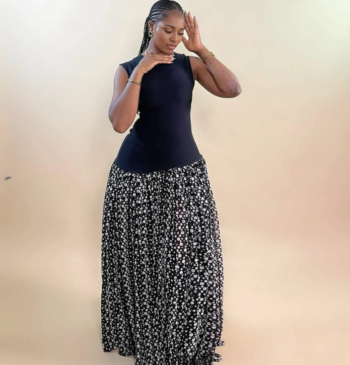 Sleeveless maxi dress with sleeveless dark bodice and black-and-white floral full skirt