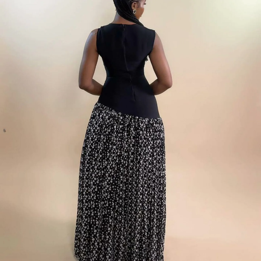 Back view sleeveless maxi dress with dark fitted bodice and black floral contrast skirt