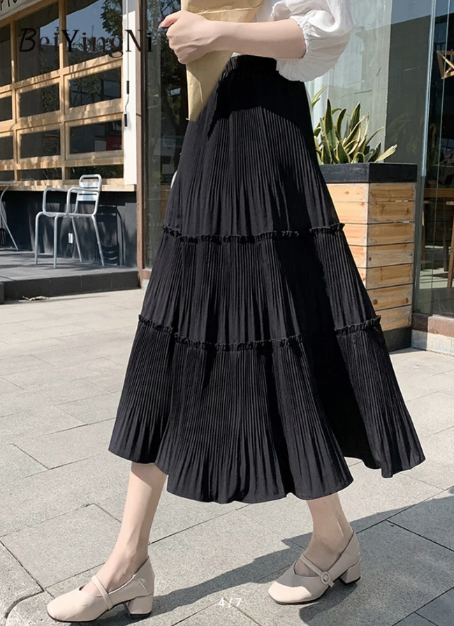 Black tiered pleated skirt with stretch waistband and tiered ruffle hem