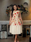 Sleeveless ivory floral midi dress with a fitted waist and flared skirt