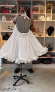 White halter open-back dress with bow tie and ruffled, flowy hem