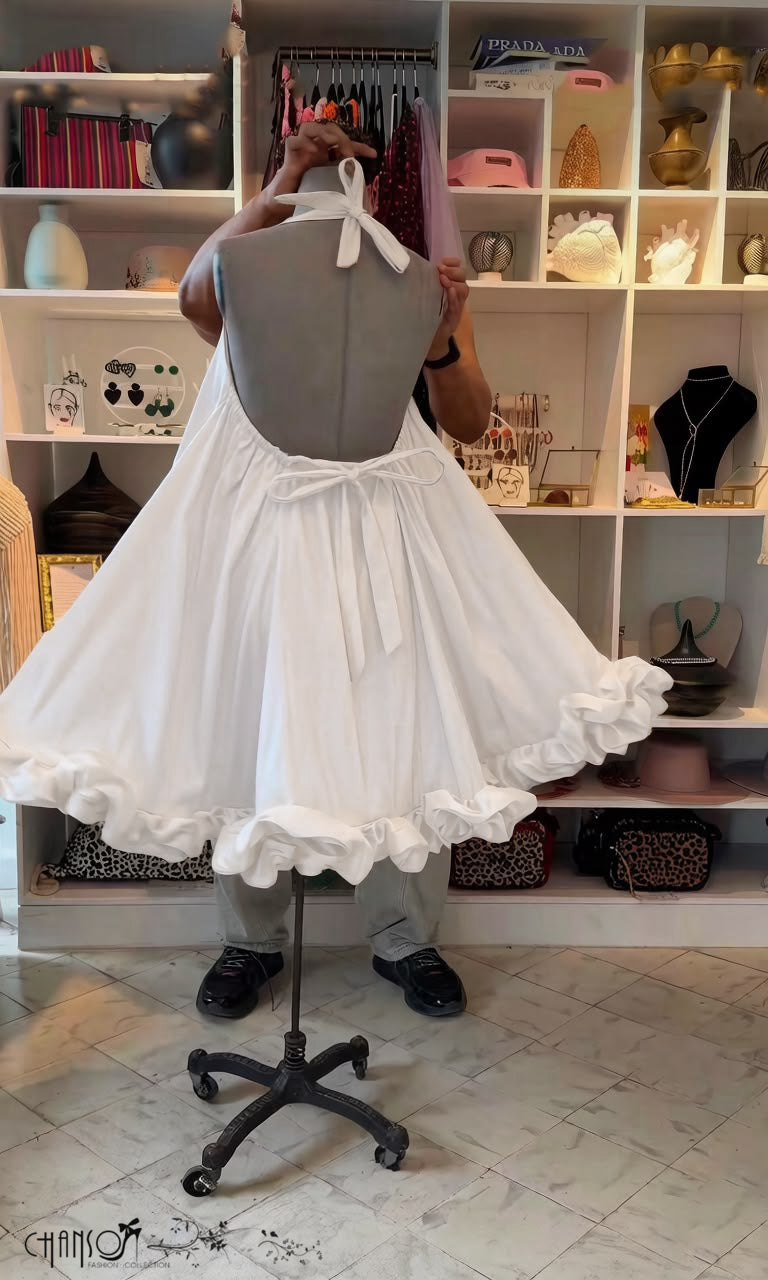 White halter open-back dress with bow tie and ruffled, flowy hem