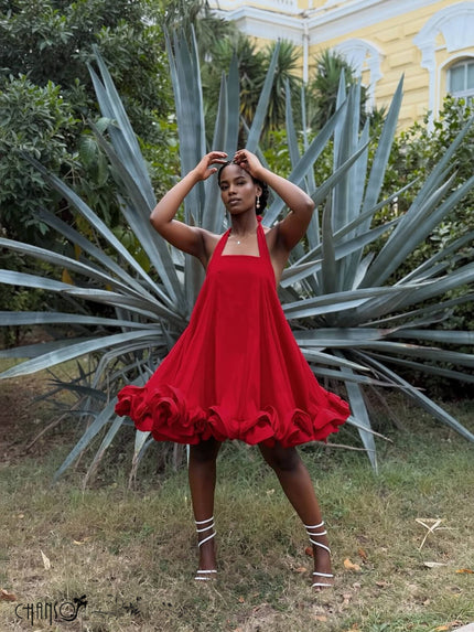 Red halter open-back dress with ruffled hem and flared skirt