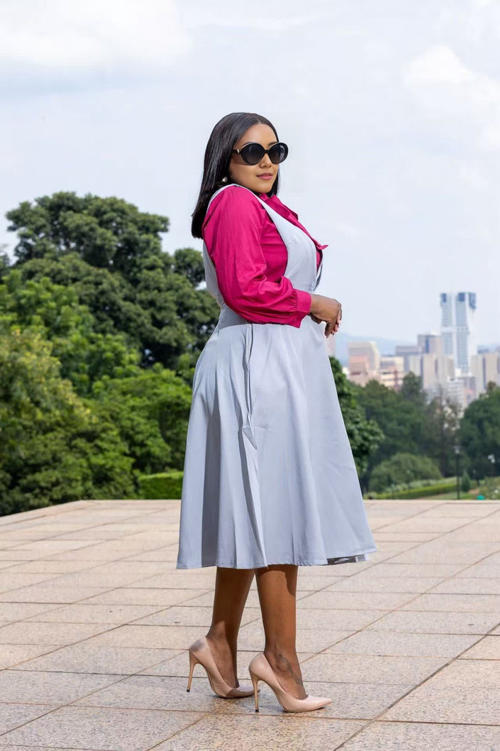 Light blue suspender midi dress, side view, with V-neck and flared skirt