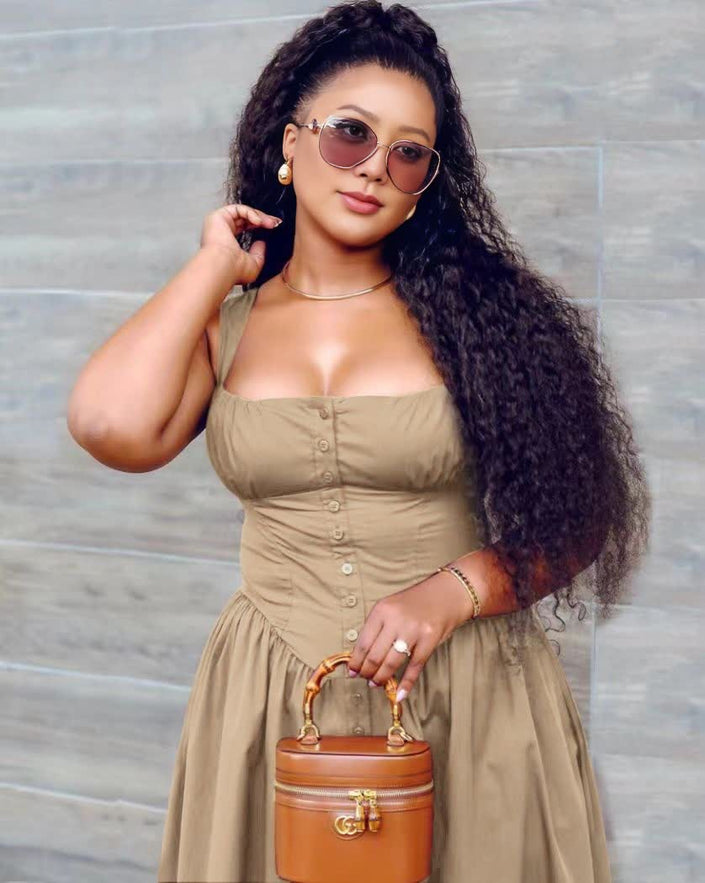 Tan midi dress with button-front bodice and gathered, flowing skirt