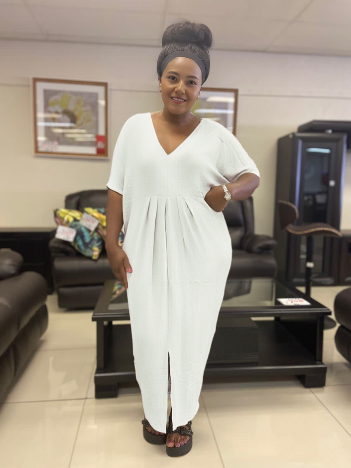 Light cream v-neck maxi dress with short sleeves, gathered bodice and front slit