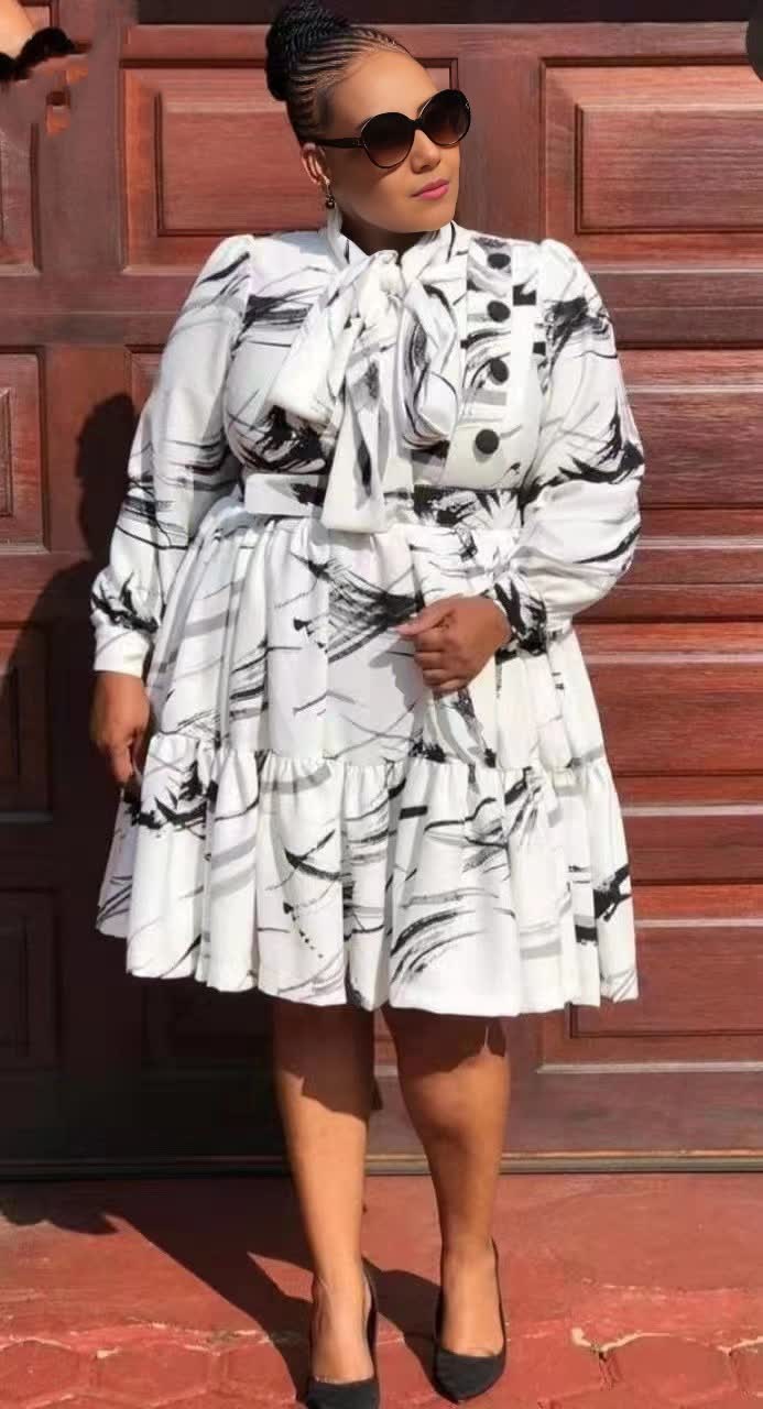 Ruffle midi dress in white with black abstract print, tiered skirt, long sleeves