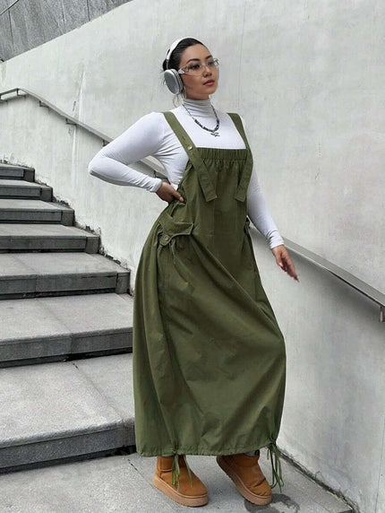 Army-green workwear maxi dress with adjustable tie straps and front pocket detail