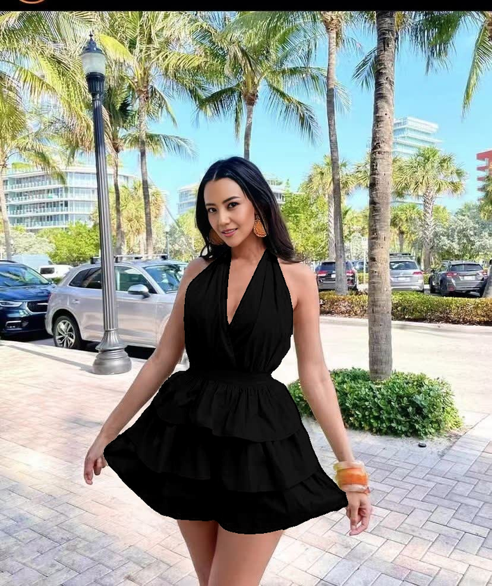 Black halter layered jumpsuit with deep V neckline and tiered ruffle skirt