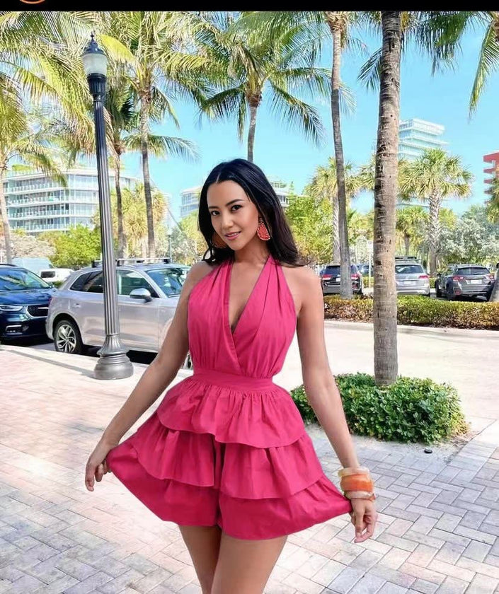 Rose pink halter layered jumpsuit with deep V neckline and tiered ruffle skirt