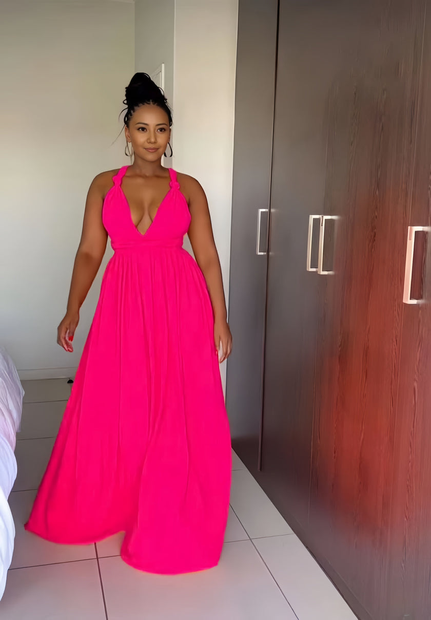 Hot pink halter maxi dress with plunging V neckline and flowy skirt