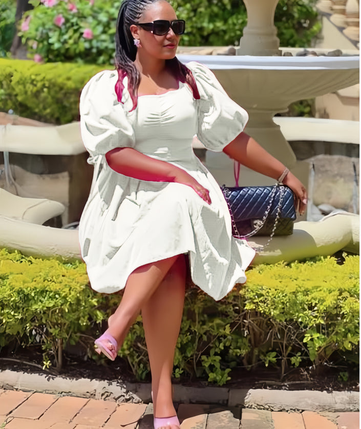 White puff sleeve A-line dress with ruched bodice and gathered skirt