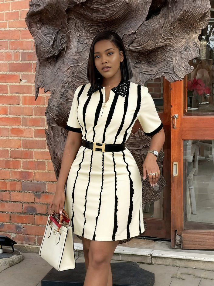 Cream striped V-neck dress with short sleeves, fitted skirt, and gold waist belt