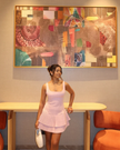 Light pink sleeveless mini dress with pleated flared skirt and scoop neckline