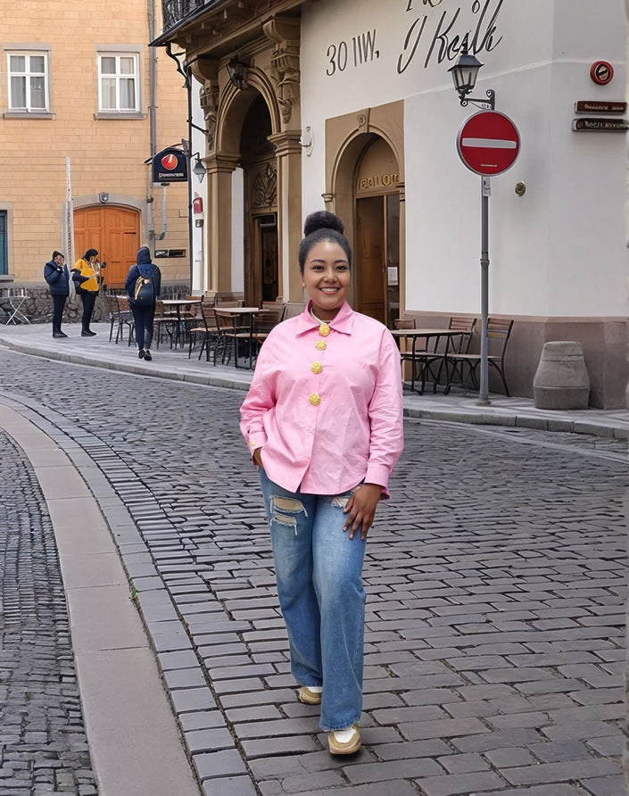 Pink vintage style shirt with gold button accents, long sleeves and collar
