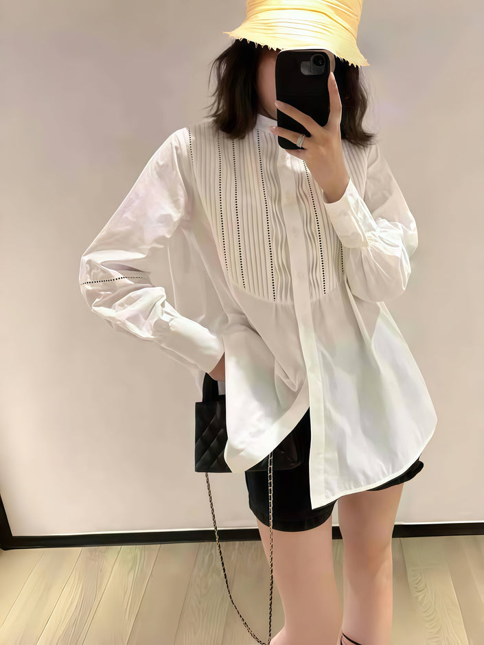 White pleated long-sleeve blouse with vertical texture and flared cuffs