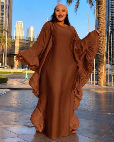 Brown loose maxi dress with dramatic ruffled sleeves and flowing silhouette