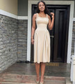 Nude pleated maxi dress with square neckline and gathered straps