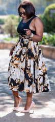 Pleated midi skirt with abstract print in black and cream, full flare silhouette