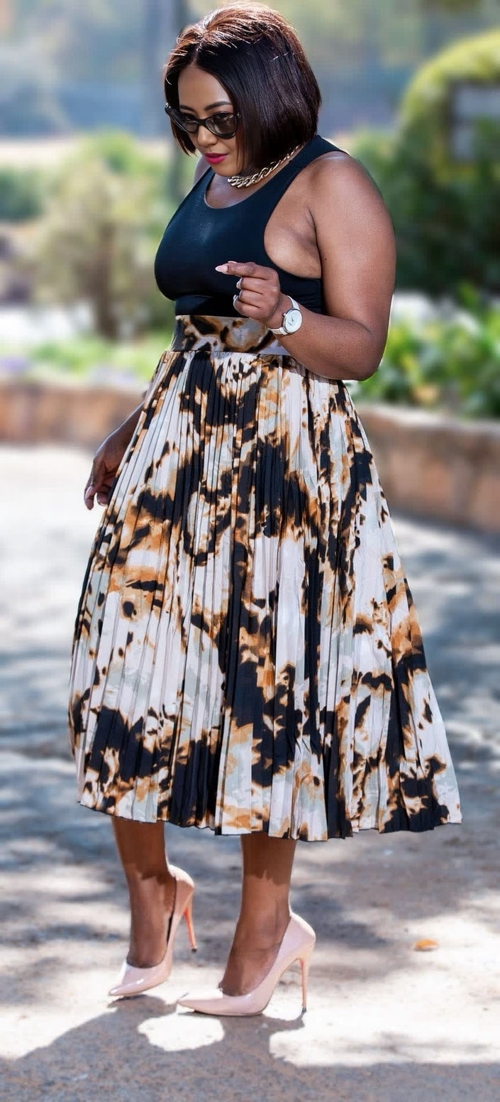 Pleated midi skirt with abstract print in black and cream, full flare silhouette