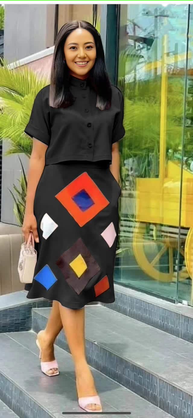 Black midi skirt with geometric diamond print panels and button-front silhouette