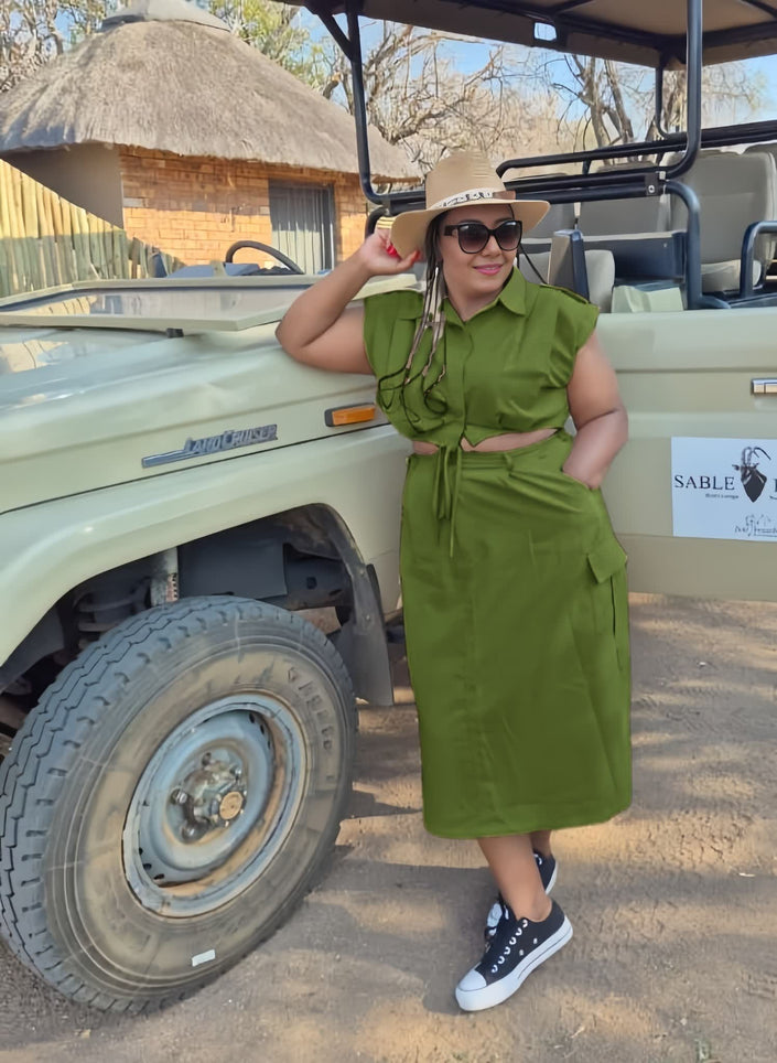 Olive-drab midi dress with front waist tie, sleeveless, gathered at waist.