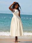 Beige midi dress with bow-tie adjustable straps, sleeveless fitted bodice and flared skirt