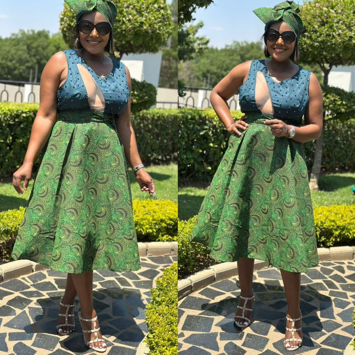 Sleeveless A-line midi dress in green and teal African print, V-neck with fitted bodice