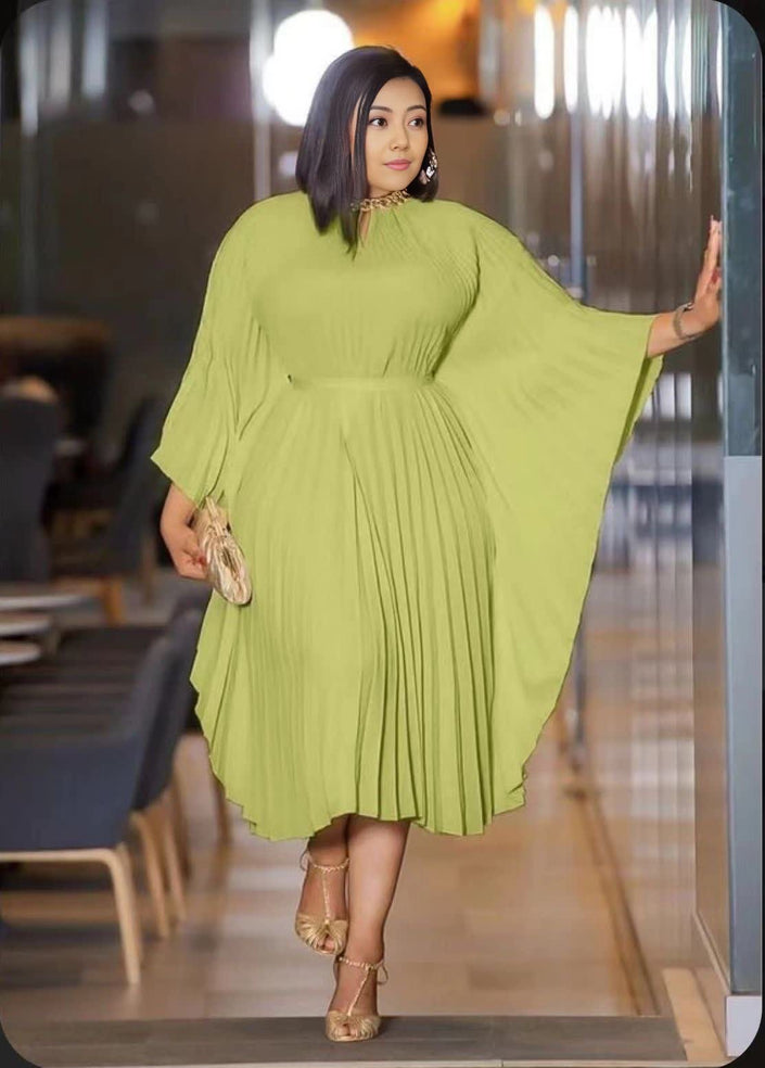 Pleated midi dress in light green with gathered waist and long flared sleeves.