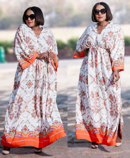 White maxi dress with geometric floral print, long sleeves, V-neck, orange hem trim