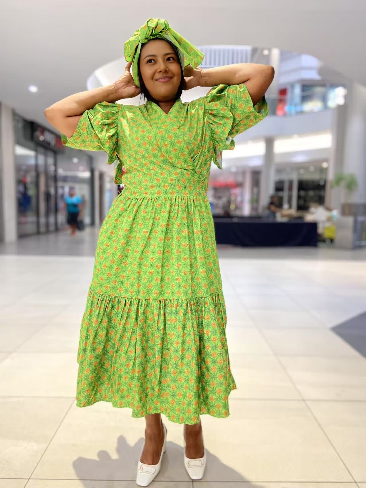 Green midi dress with short ruffled sleeves and tiered skirt, allover small print