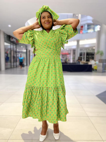 Green midi dress with short ruffled sleeves and tiered skirt, allover small print