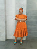 Orange midi dress with short ruffled sleeves and tiered skirt, small allover pattern