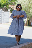 Blue striped puff-sleeve dress with gathered waist, swaying knee-length hem