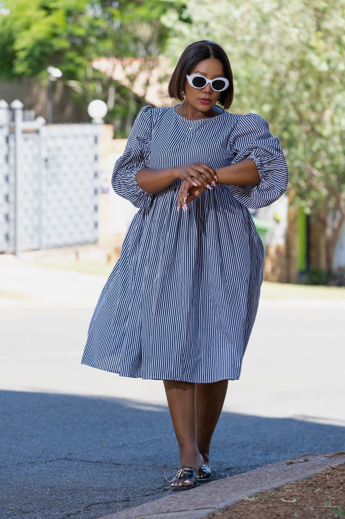 Blue striped puff-sleeve dress with gathered waist, swaying knee-length hem