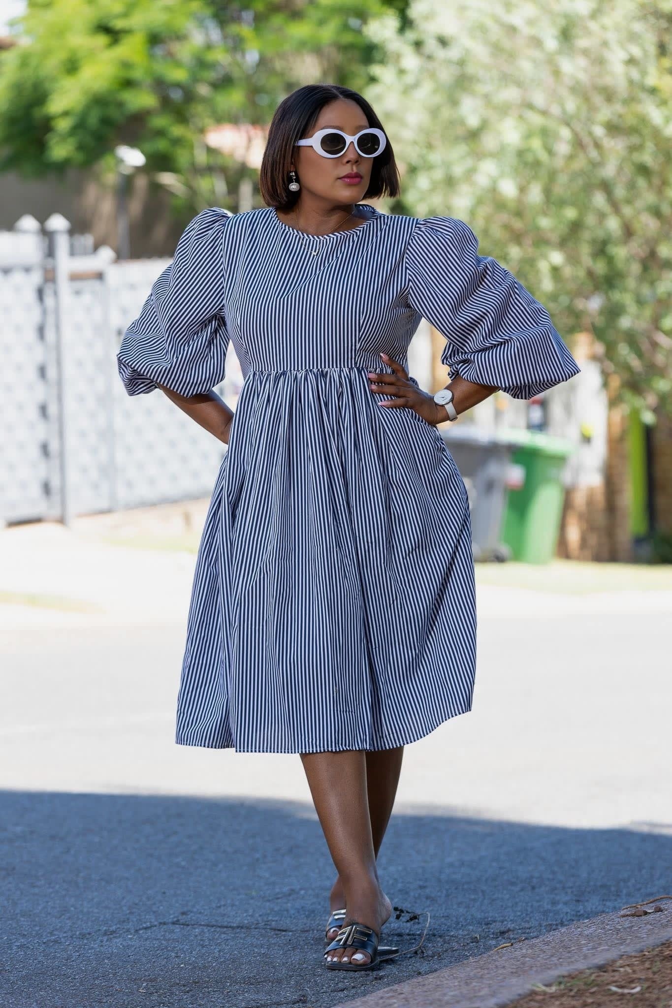 Blue striped puff-sleeve dress with gathered waist and full skirt, front view