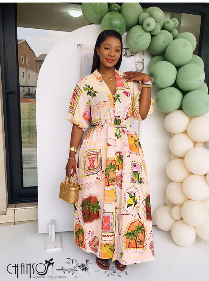 Off-white maxi dress with geometric print, puff sleeves, and cinched waist.